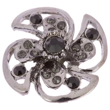 Metallischer Zierknopf in Blumenform besetzt mit schwarzen und grauen Strasssteinen